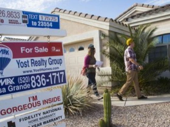 Stock image of a for-sale sign in front of a house