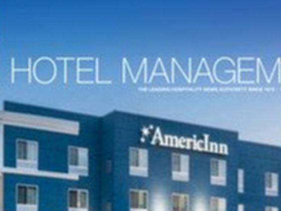 Hotel Management (HM) logo, with AmericInn building in the background