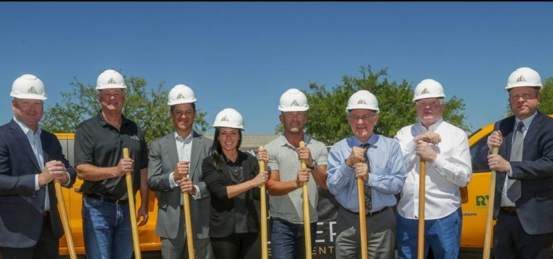 The Caliber construction team poses with shovels