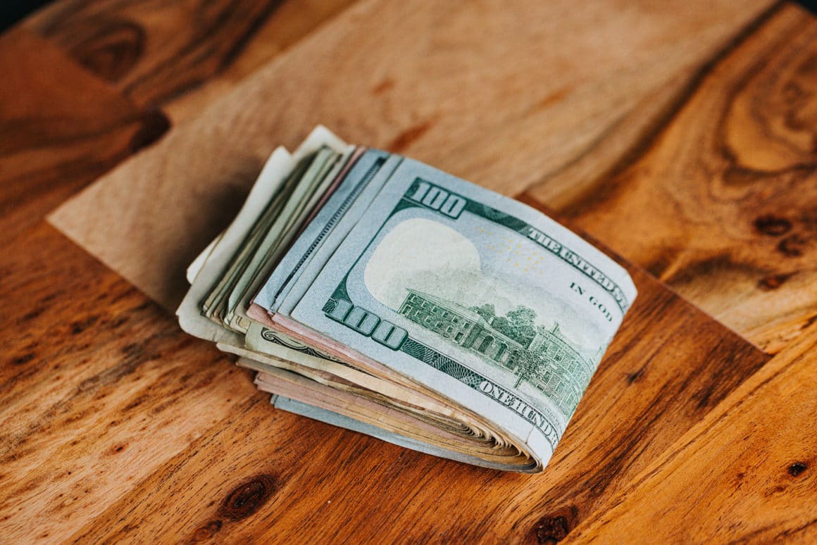Photo of cash on a wood table