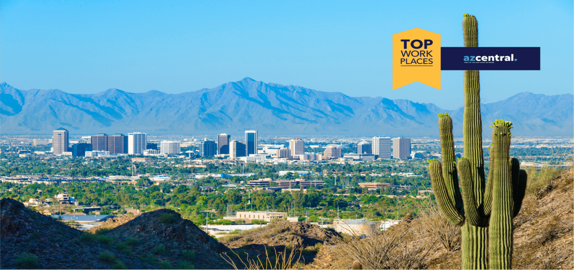 A road sign overlooking downtown Phoenix from a mountain - "AZ Top 2021 Workplaces"