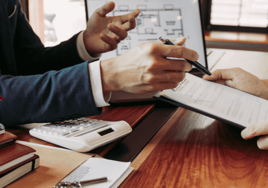 an advisor and his investor client are looking over a chart of different types of alternative investment management strategies